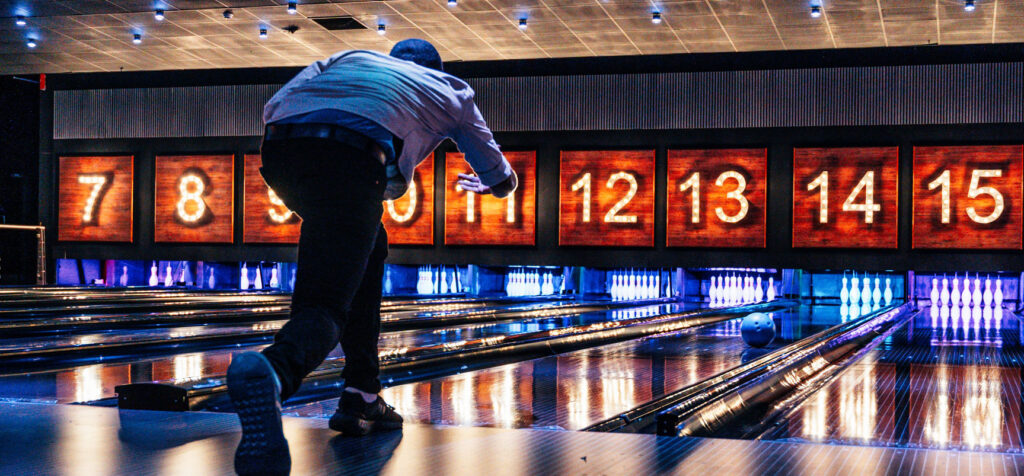 a man bowling in a bowling alley